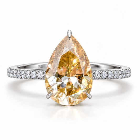 Champagne pear moissanite engagement ring with three prongs and pave band in white gold