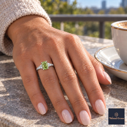 Green Emerald Cut Lab Grown Diamond Engagement Ring - Graduated Pave Shoulders in white gold, on the hand
