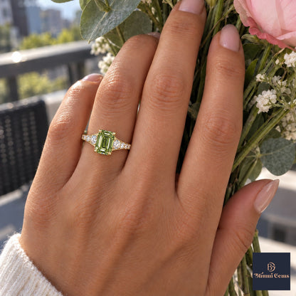 Green Emerald Cut Lab Grown Diamond Engagement Ring - Graduated Pave Shoulders in yellow gold, worn on the hand