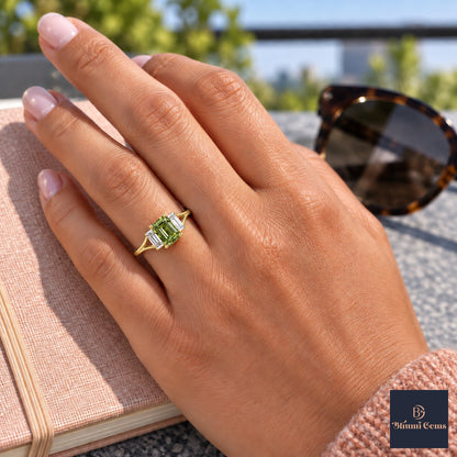 Green Emerald Cut Lab Grown Diamond Engagement Ring - Trapezoid Three Stone in yellow gold, worn on the hand