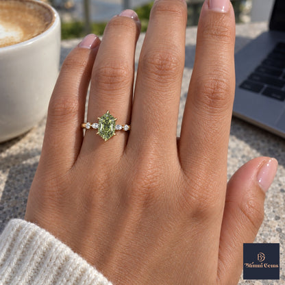 Green Hexagon Cut Lab Grown Diamond Engagement Ring - Marquise and Round Accents in yellow gold, on the hand