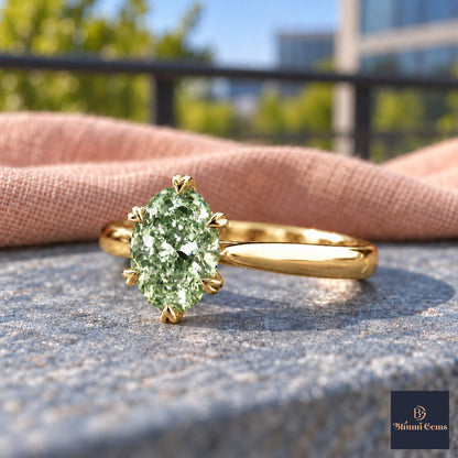Green Oval Cut Lab Grown Diamond Engagement Ring - Heart Prong Solitaire in yellow gold, close-up