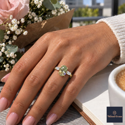 Green Oval Cut Lab Grown Diamond Engagement Ring - Leaf Bypass in yellow gold, worn on the hand