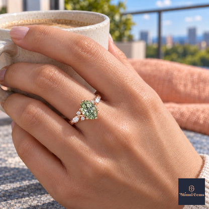 Green Oval Cut Lab Grown Diamond Engagement Ring - Leaf Cluster Shoulders in rose gold, on the hand
