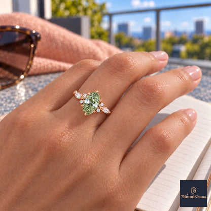 Green Oval Cut Lab Grown Diamond Engagement Ring - Leaf Cluster Shoulders in rose gold, worn on the hand