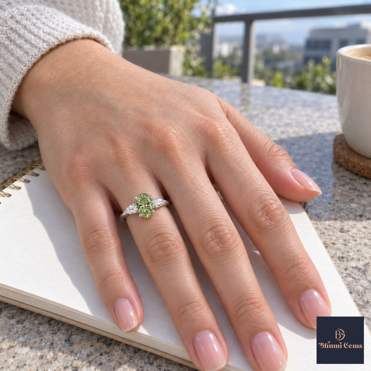 Green Oval Cut Lab Grown Diamond Engagement Ring - Pear Side Stones in white gold, worn on the hand