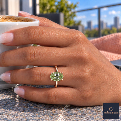 Green Oval Cut Lab Grown Diamond Engagement Ring - Six Prong Solitaire in rose gold, on the hand