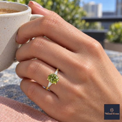 Green Oval Cut Lab Grown Diamond Engagement Ring - Tapered Baguettes in yellow gold, on the hand