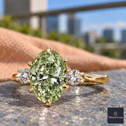 Green Oval Cut Lab Grown Diamond Engagement Ring - Three Stone in yellow gold, close-up