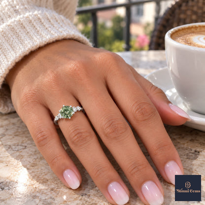 Green Round Cut Lab Grown Diamond Engagement Ring - Cluster Shoulders in white gold, on the hand