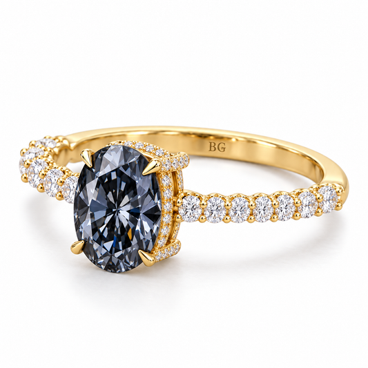 Oval grey moissanite engagement ring with pave band and hidden halo in yellow gold