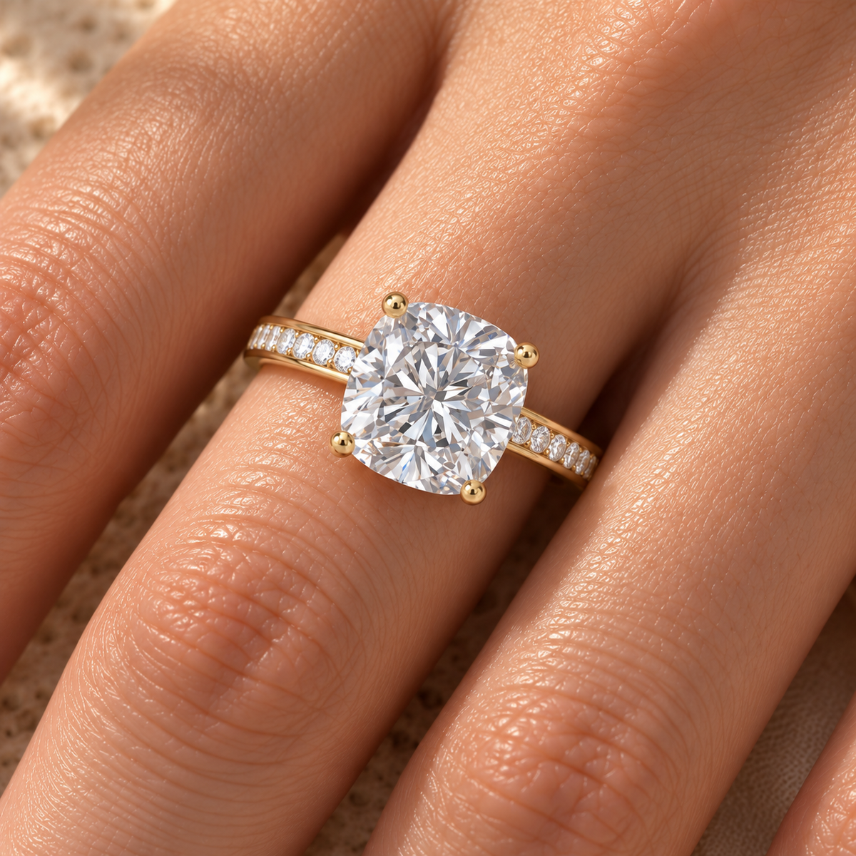 Cushion lab grown diamond channel set engagement ring worn on hand, yellow gold