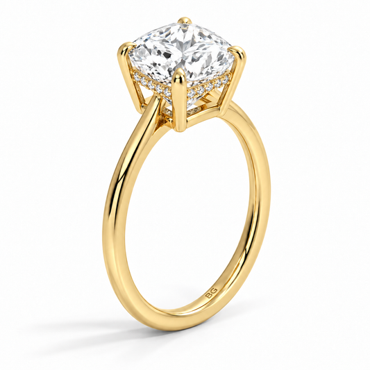 Cushion cut lab grown diamond hidden halo engagement ring with thin plain band in yellow gold