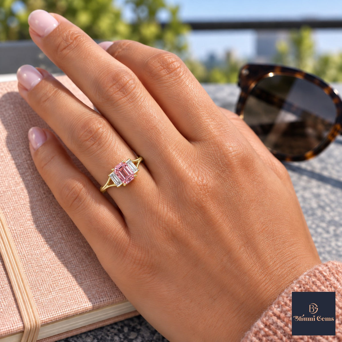 Pink Emerald Cut Lab Grown Diamond Engagement Ring - Trapezoid Three Stone in yellow gold, worn on the hand