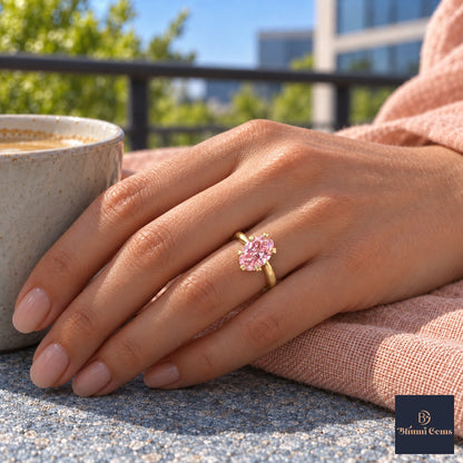 Pink Oval Cut Lab Grown Diamond Engagement Ring - Heart Prong Solitaire in yellow gold, on the hand