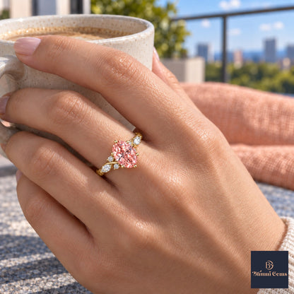 Pink Oval Cut Lab Grown Diamond Engagement Ring - Leaf Cluster Shoulders in yellow gold, on the hand