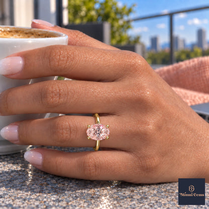 Pink Oval Cut Lab Grown Diamond Engagement Ring - Six Prong Solitaire in yellow gold, on the hand