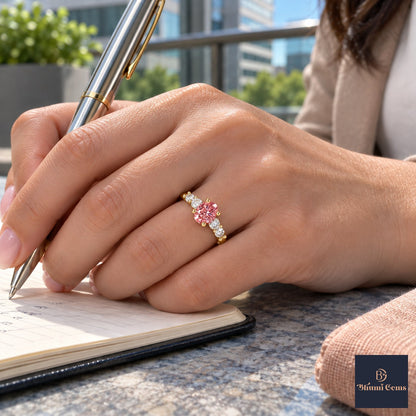 Pink Round Cut Lab Grown Diamond Engagement Ring - Marquise and Round Station Band in yellow gold, on the hand