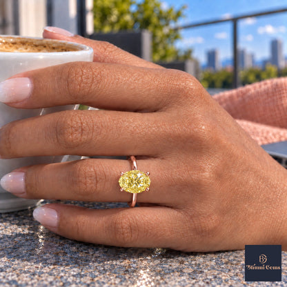 Yellow Oval Cut Lab Grown Diamond Engagement Ring - Six Prong Solitaire in rose gold, on the hand