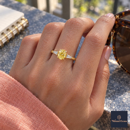 Yellow Oval Cut Lab Grown Diamond Engagement Ring - Tapered Baguettes in yellow gold, worn on the hand
